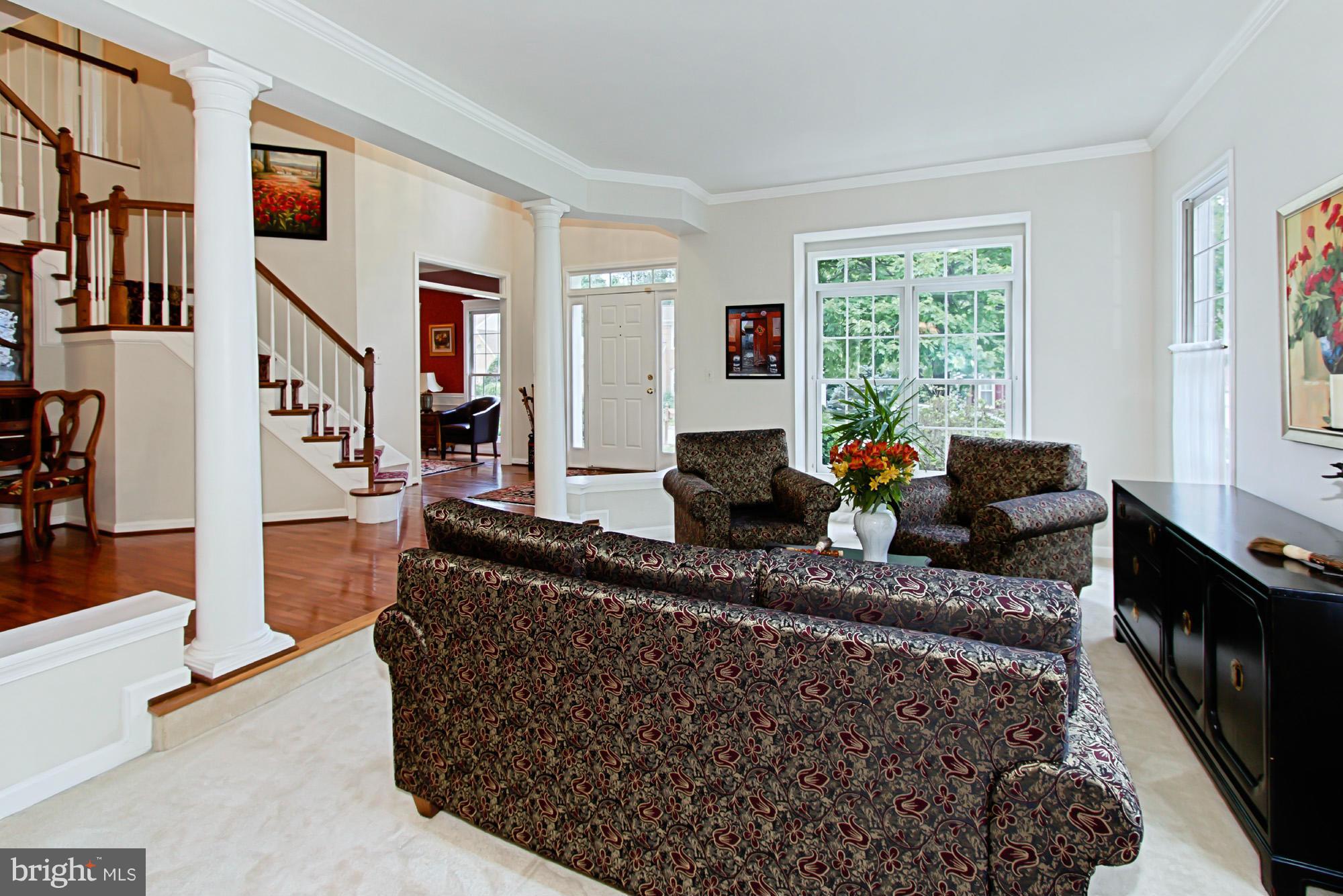 8127 Ridge Creek Way Springfield, VA 22153 - Photo 7 of 30 a living room with furniture a flat screen tv and a large window