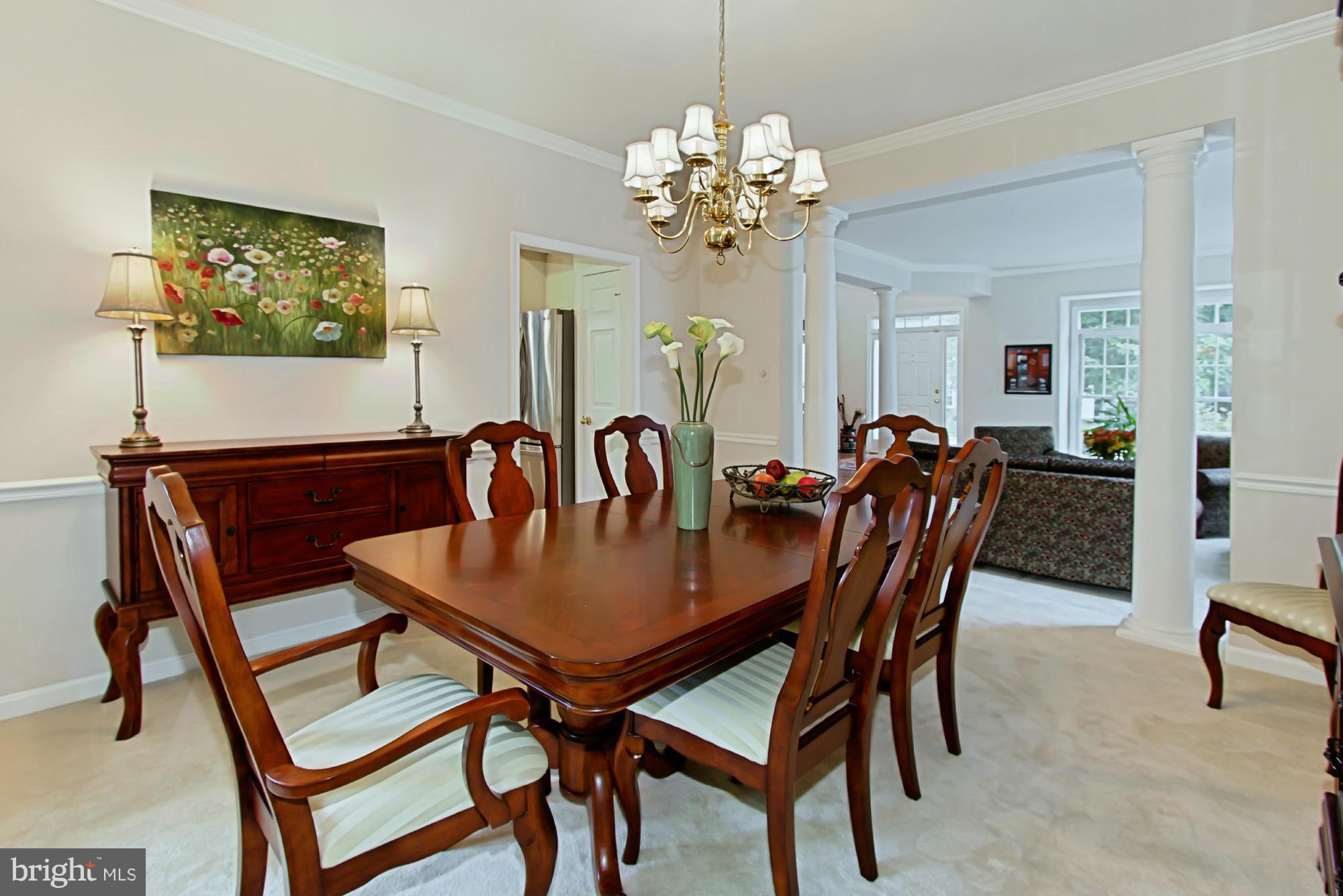 8127 Ridge Creek Way Springfield, VA 22153 - Photo 9 of 30 a view of a dining room with furniture and chandelier