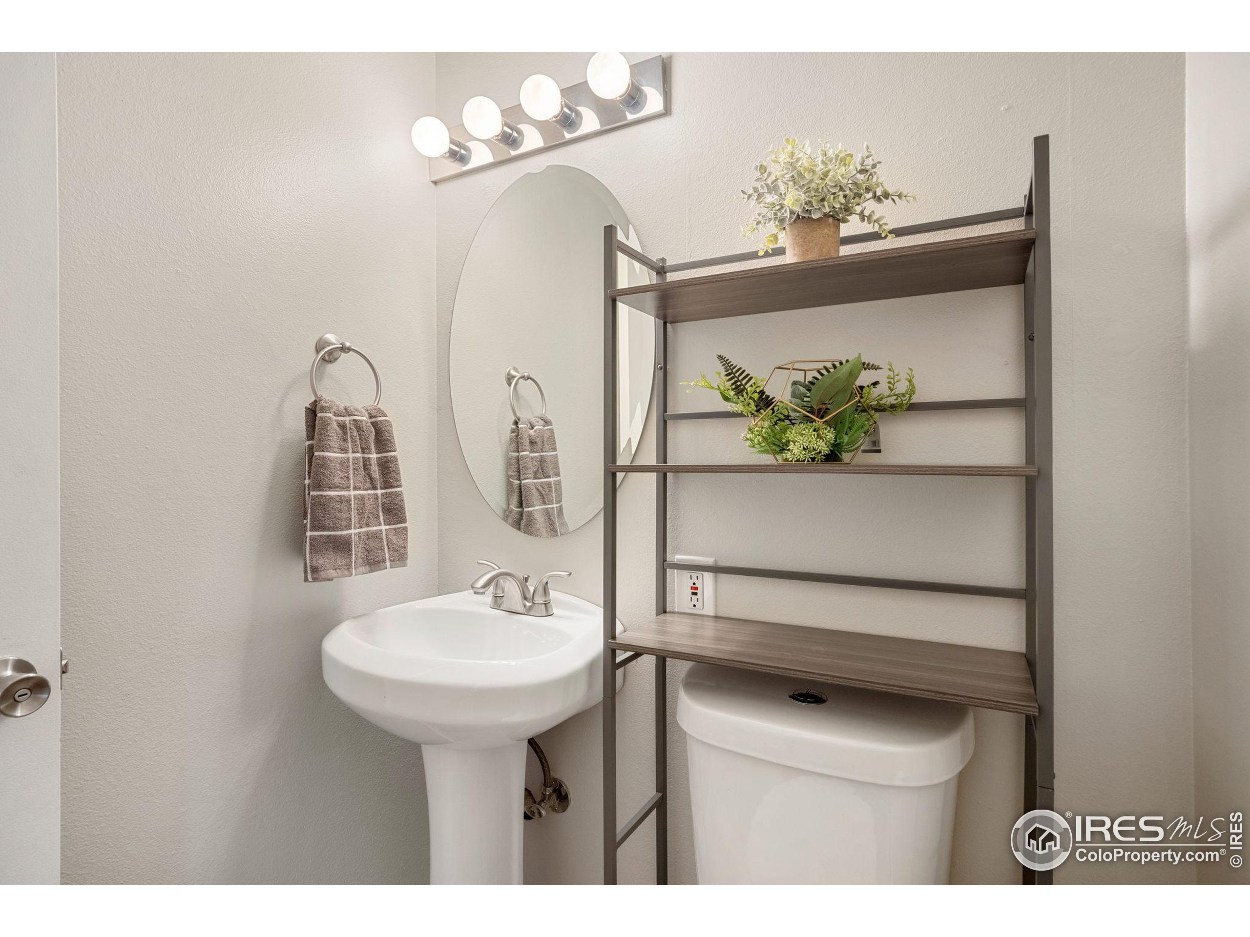 219 Chestnut Street Windsor, CO 80550 - Photo 17 of 23 a bathroom with a sink vanity and a mirror