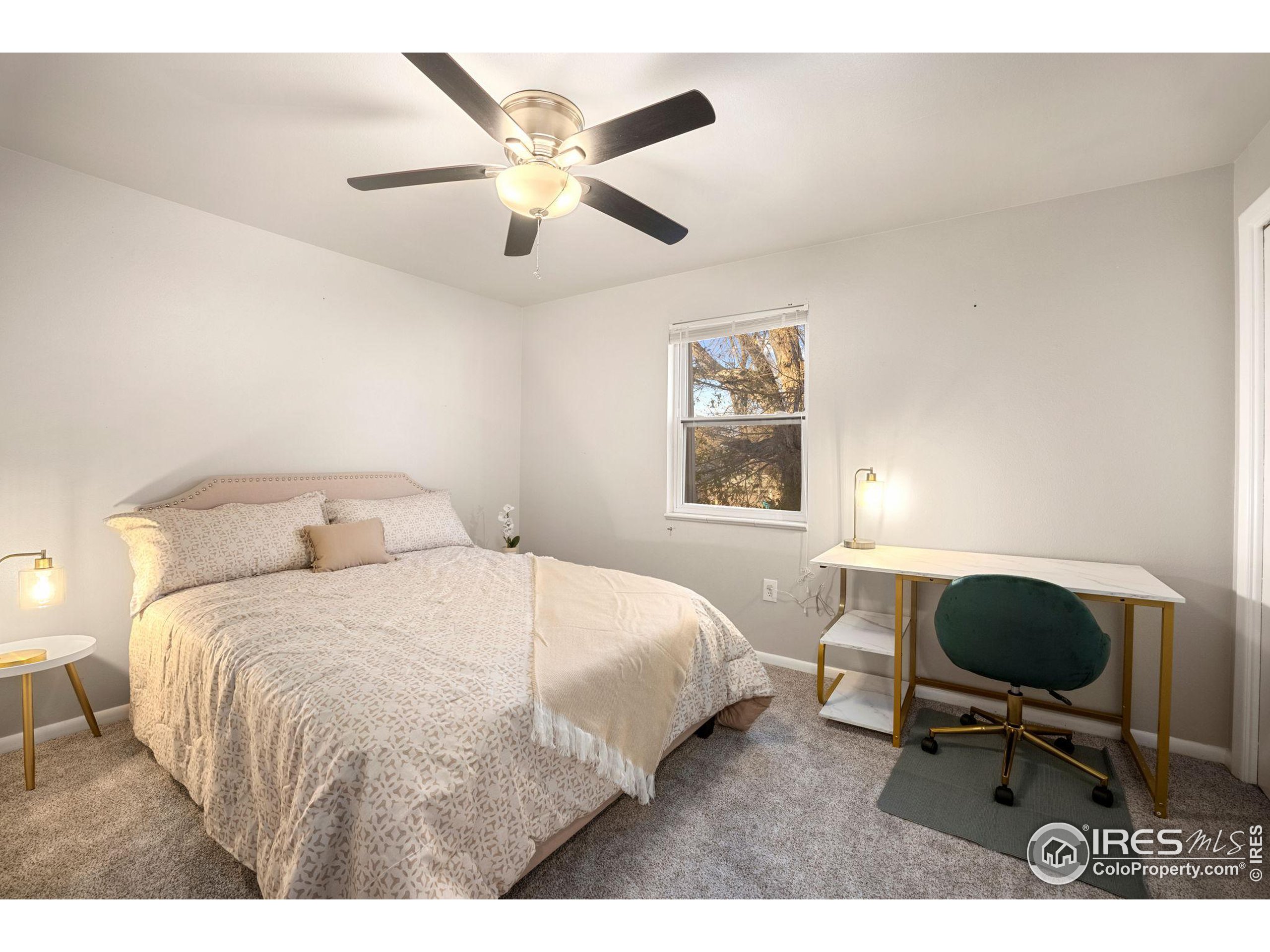 219 Chestnut Street Windsor, CO 80550 - Photo 18 of 23 a bedroom with a bed a chair and a large window