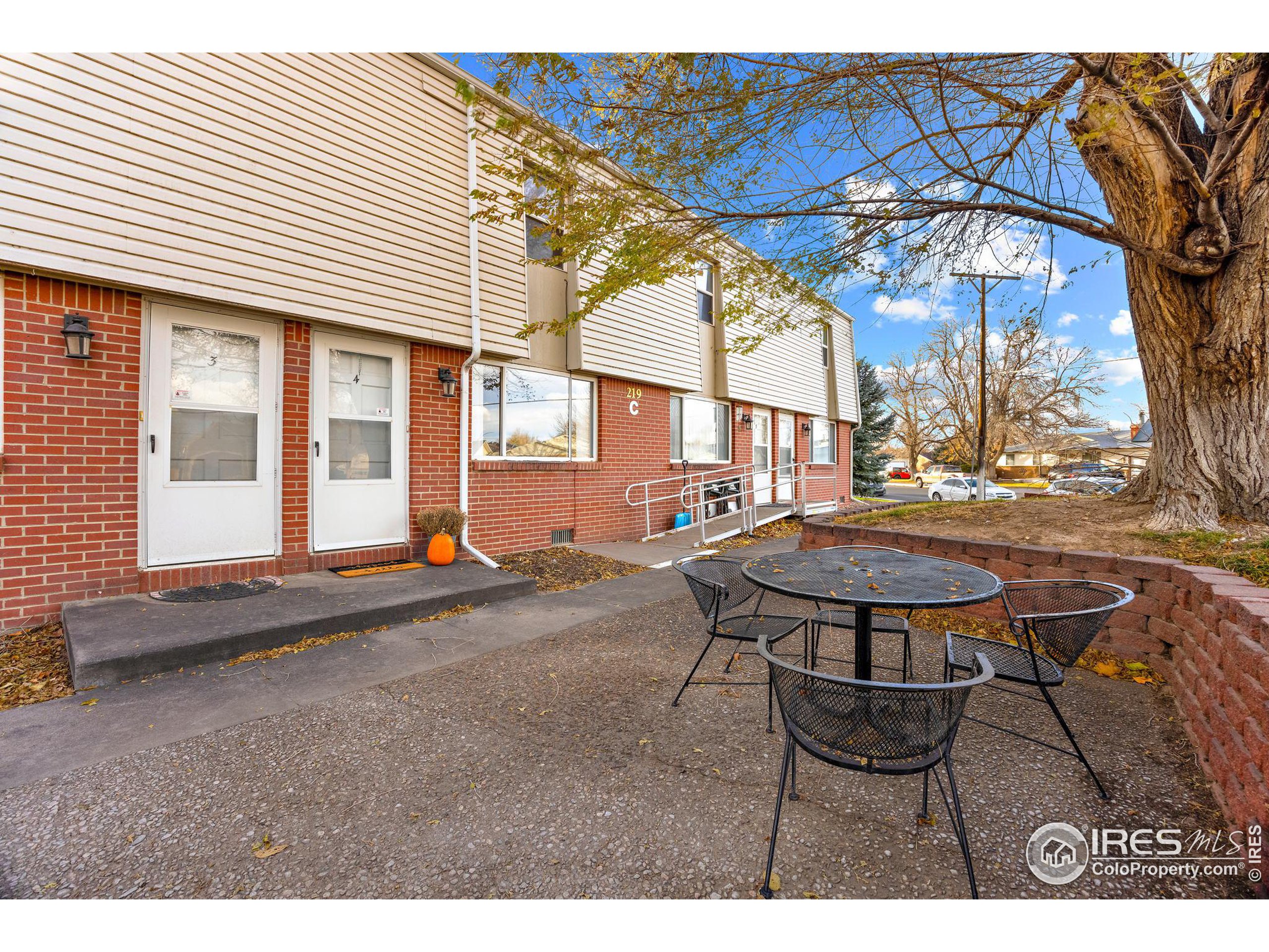 219 Chestnut Street Windsor, CO 80550 - Photo 2 of 23 a view of a patio with table and chairs and a barbeque