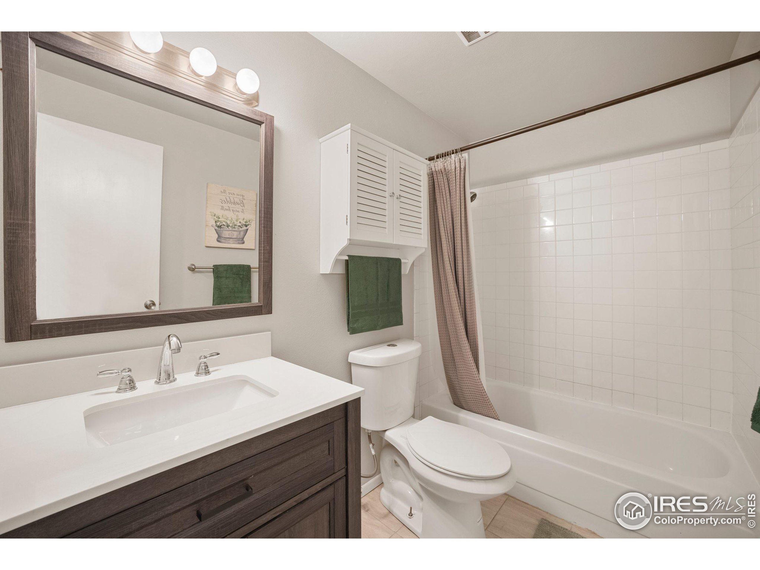 219 Chestnut Street Windsor, CO 80550 - Photo 21 of 23 a bathroom with a sink a toilet a mirror and shower