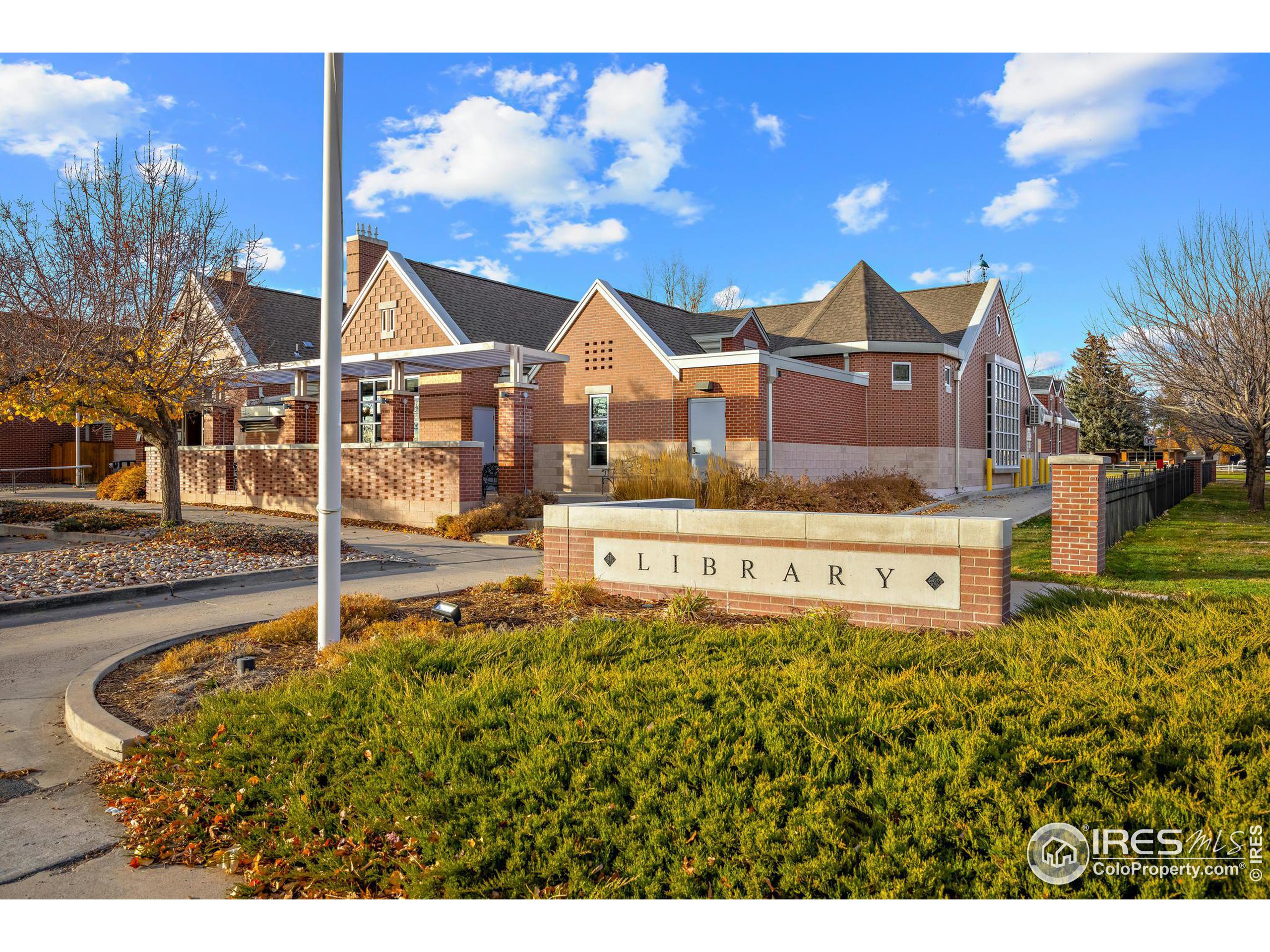 219 Chestnut Street Windsor, CO 80550 - Photo 22 of 23 a view of a house with a big yard and potted plants