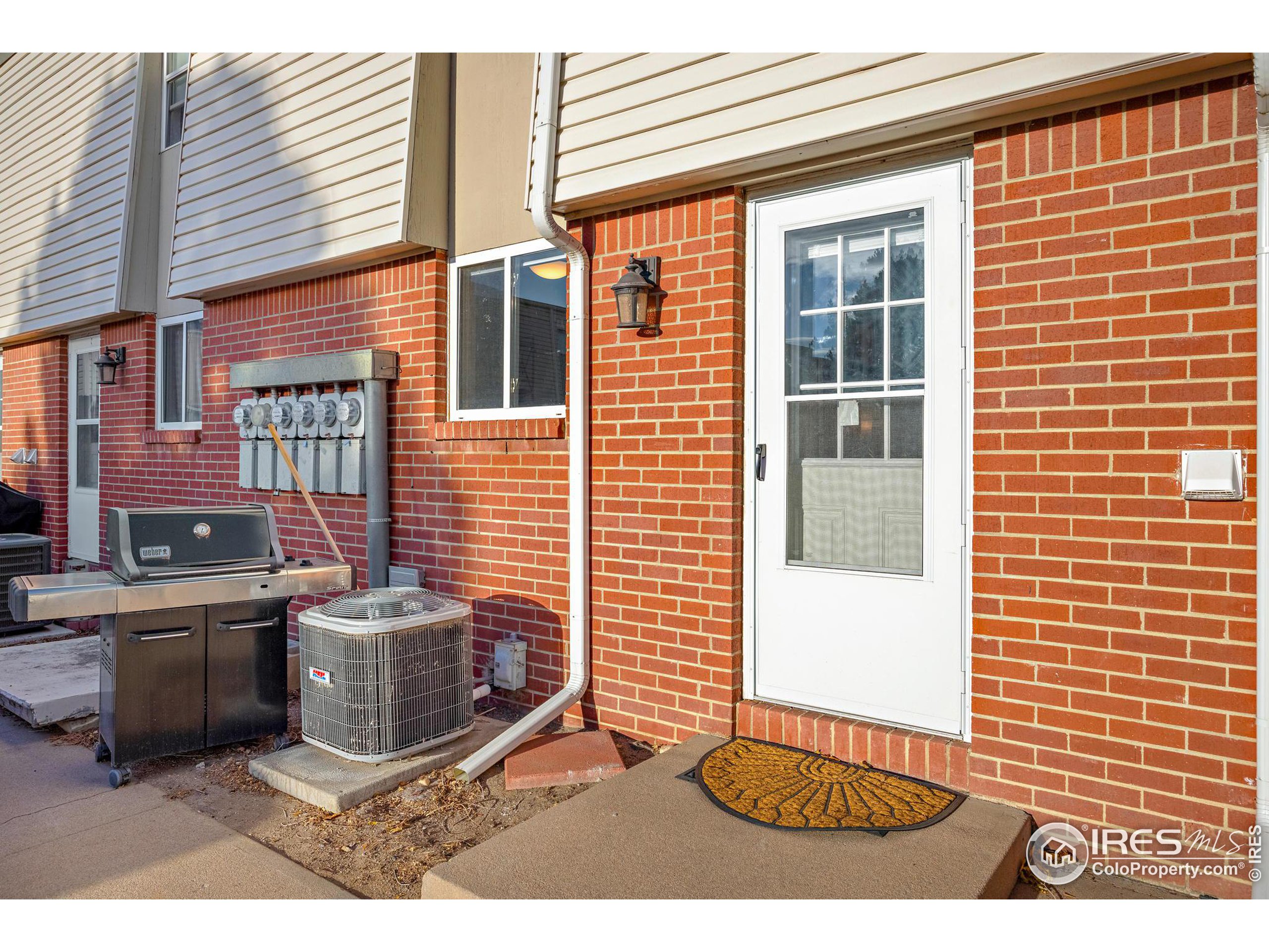 219 Chestnut Street Windsor, CO 80550 - Photo 5 of 23 a view of a porch with a table and chairs and potted plants