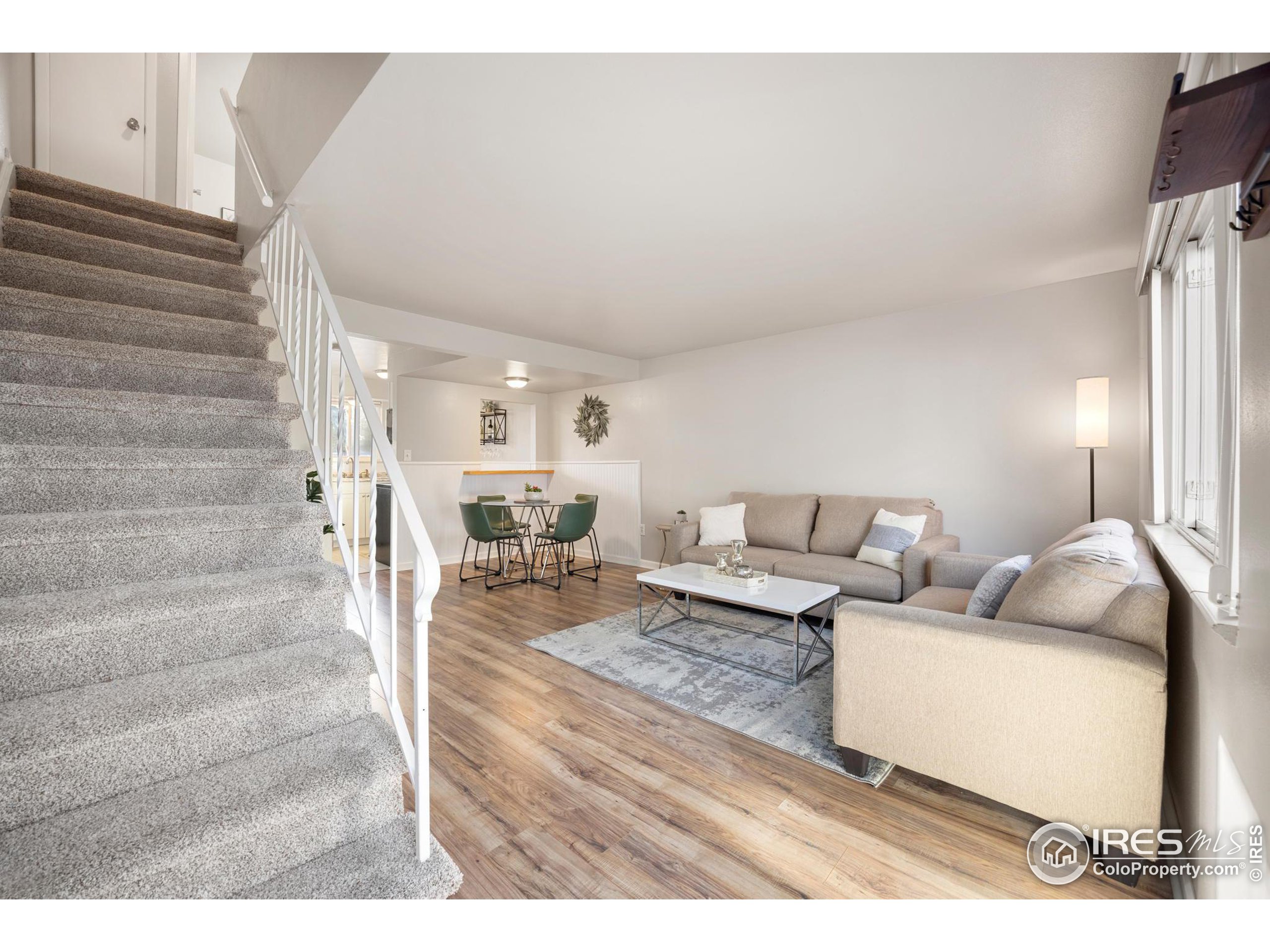 219 Chestnut Street Windsor, CO 80550 - Photo 8 of 23 a living room with furniture and a painting on the wall