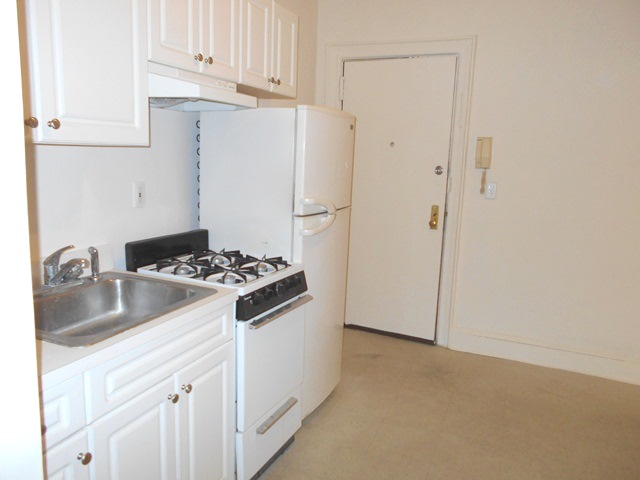 170-172 Spring Street, Unit 7 Manhattan, NY 10012 - Photo 2 of 8 a kitchen with a stove and a refrigerator