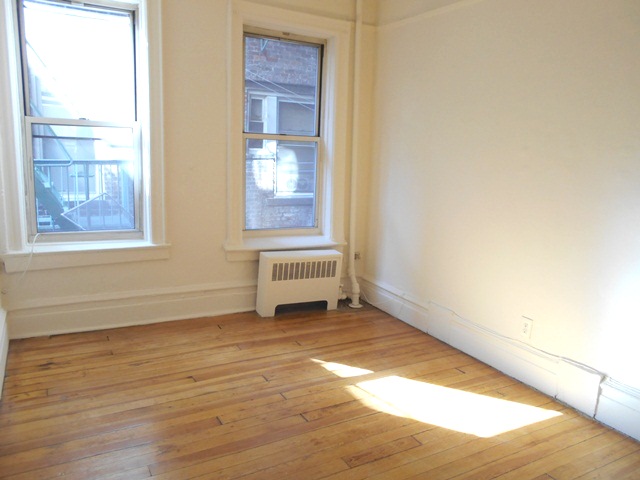 170-172 Spring Street, Unit 7 Manhattan, NY 10012 - Photo 4 of 8 a view of an empty room and window