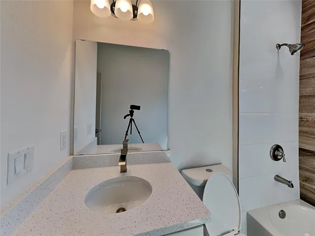 a bathroom with a sink and mirror
