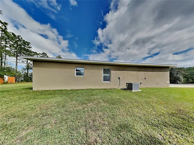a view of a backyard of the house