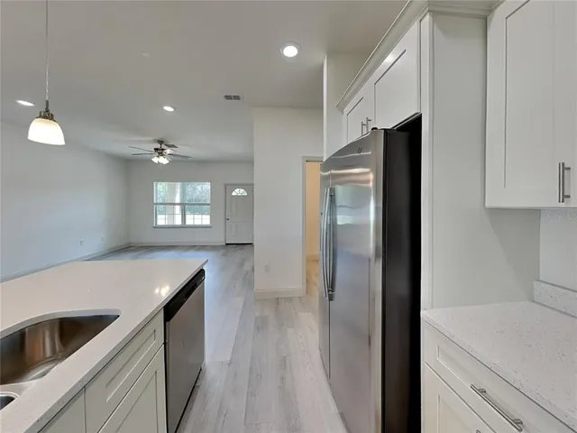 a kitchen with a refrigerator and a sink