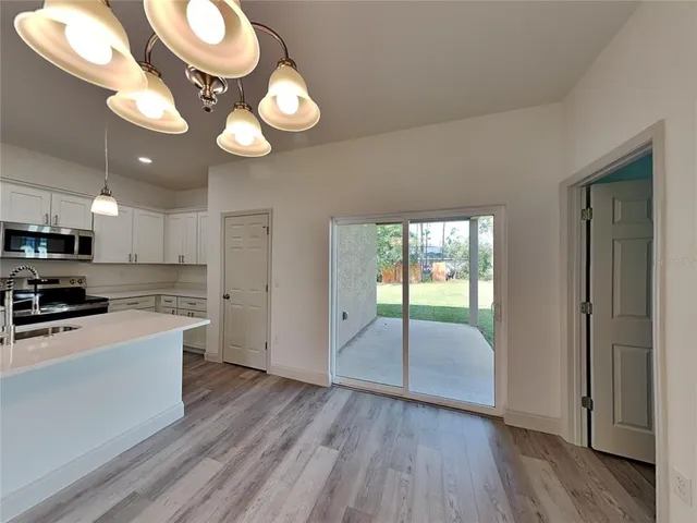 a view of a kitchen with a sink dishwasher and wooden floor