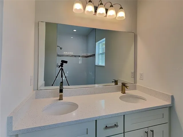 a bathroom with a sink and a mirror