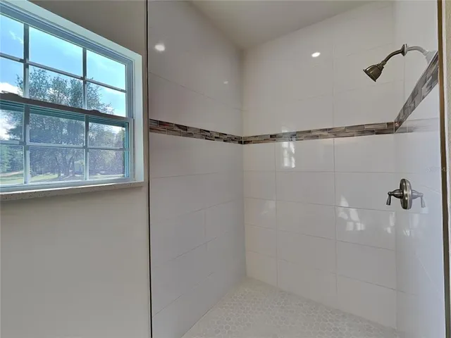 a bathroom with a glass shower door