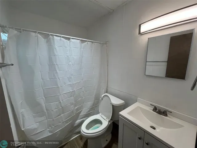 a white toilet sitting next to a bathroom sink