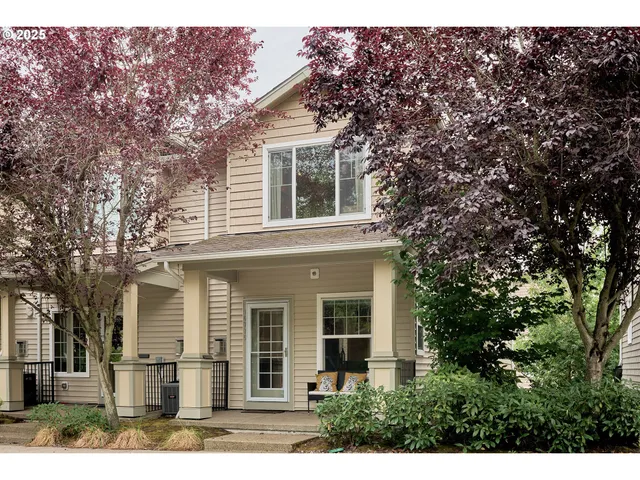 front view of a house with a tree