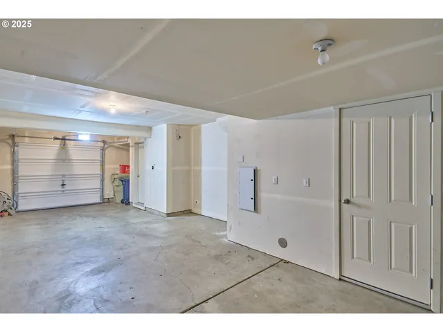 a view of a house with a yard and large tree