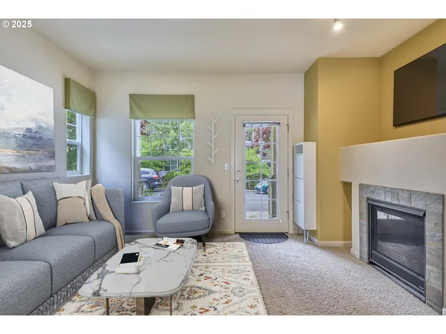 a living room with furniture and a fireplace