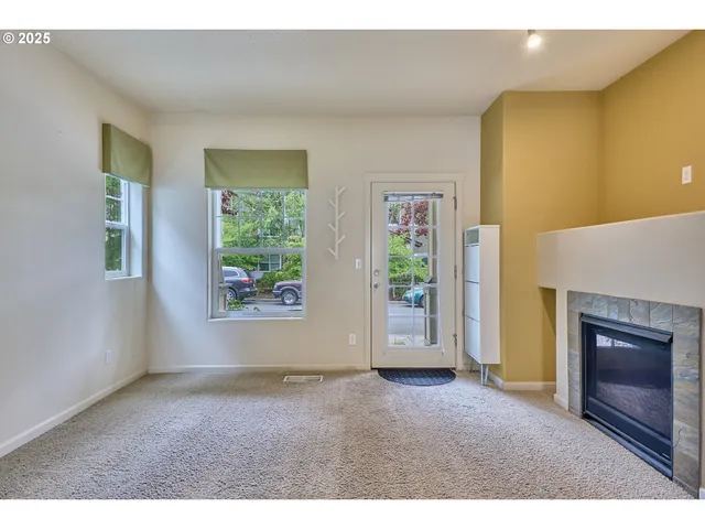 a view of empty room with windows and fireplace