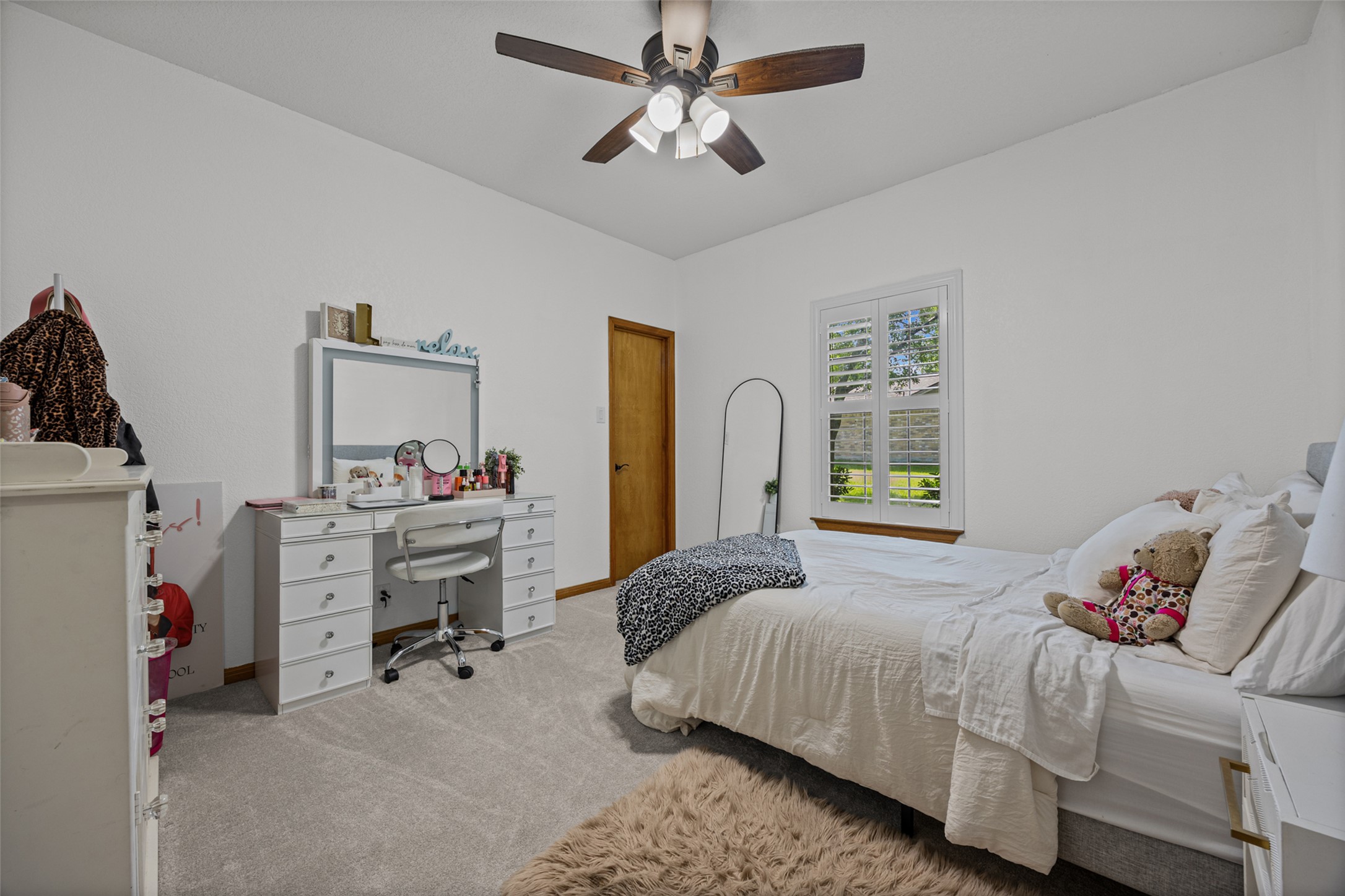 2000 Spinel Road Pflugerville, TX 78660 - Photo 13 of 31 A well-lit bedroom with soft carpeting and natural light streaming through a window.