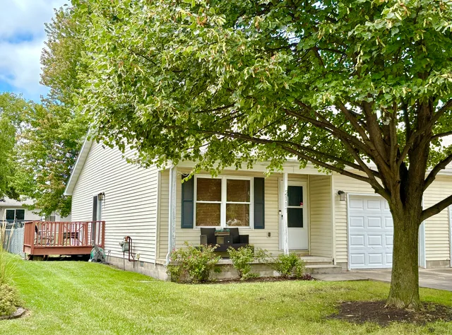 a front view of a house with a yard and porch
