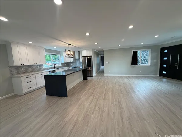 a large kitchen with stainless steel appliances granite countertop a large center island and a stove