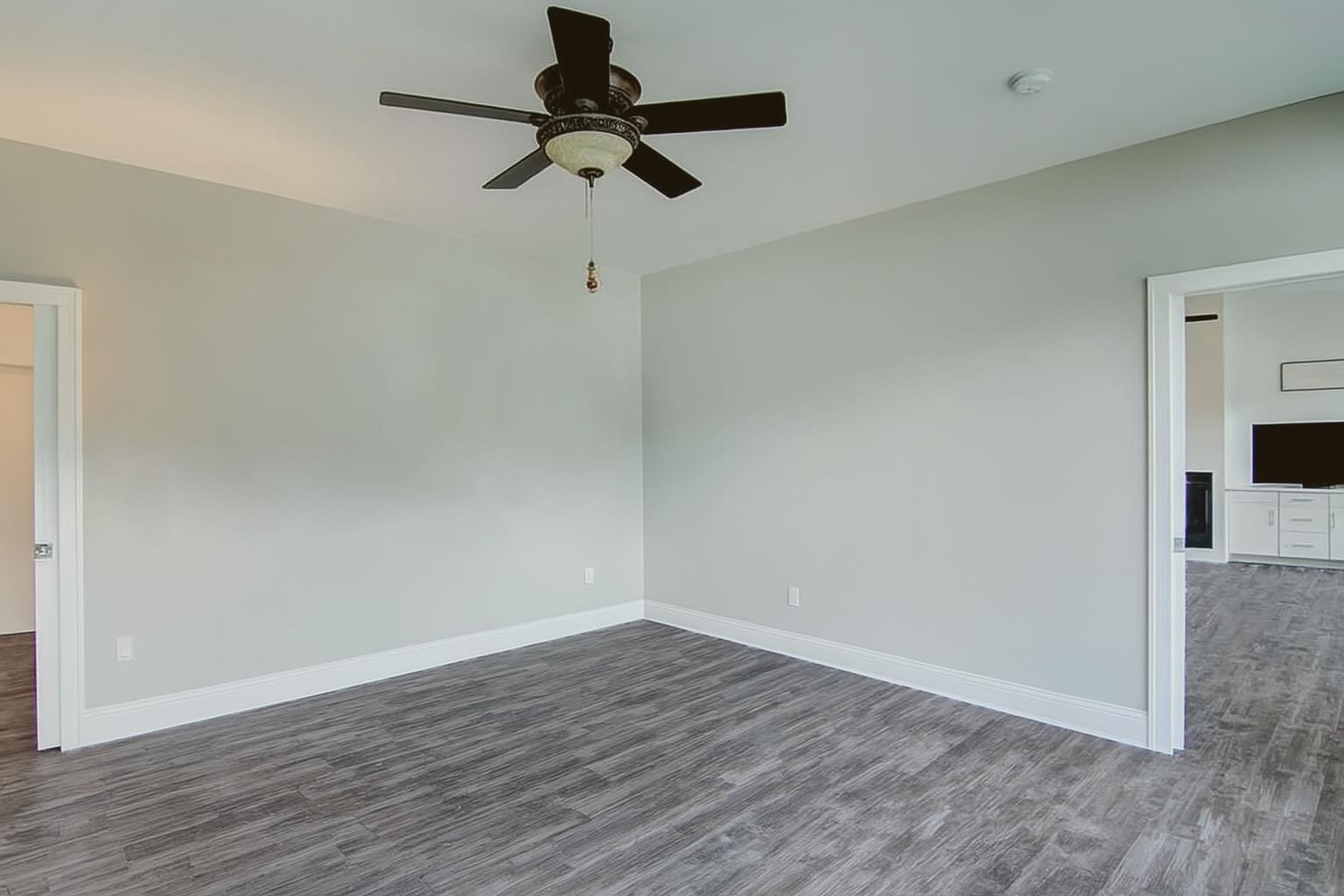 6030 Mitchell Road Iron River, WI 54847 - Photo 21 of 45 Empty room featuring dark wood-style flooring and a ceiling fan