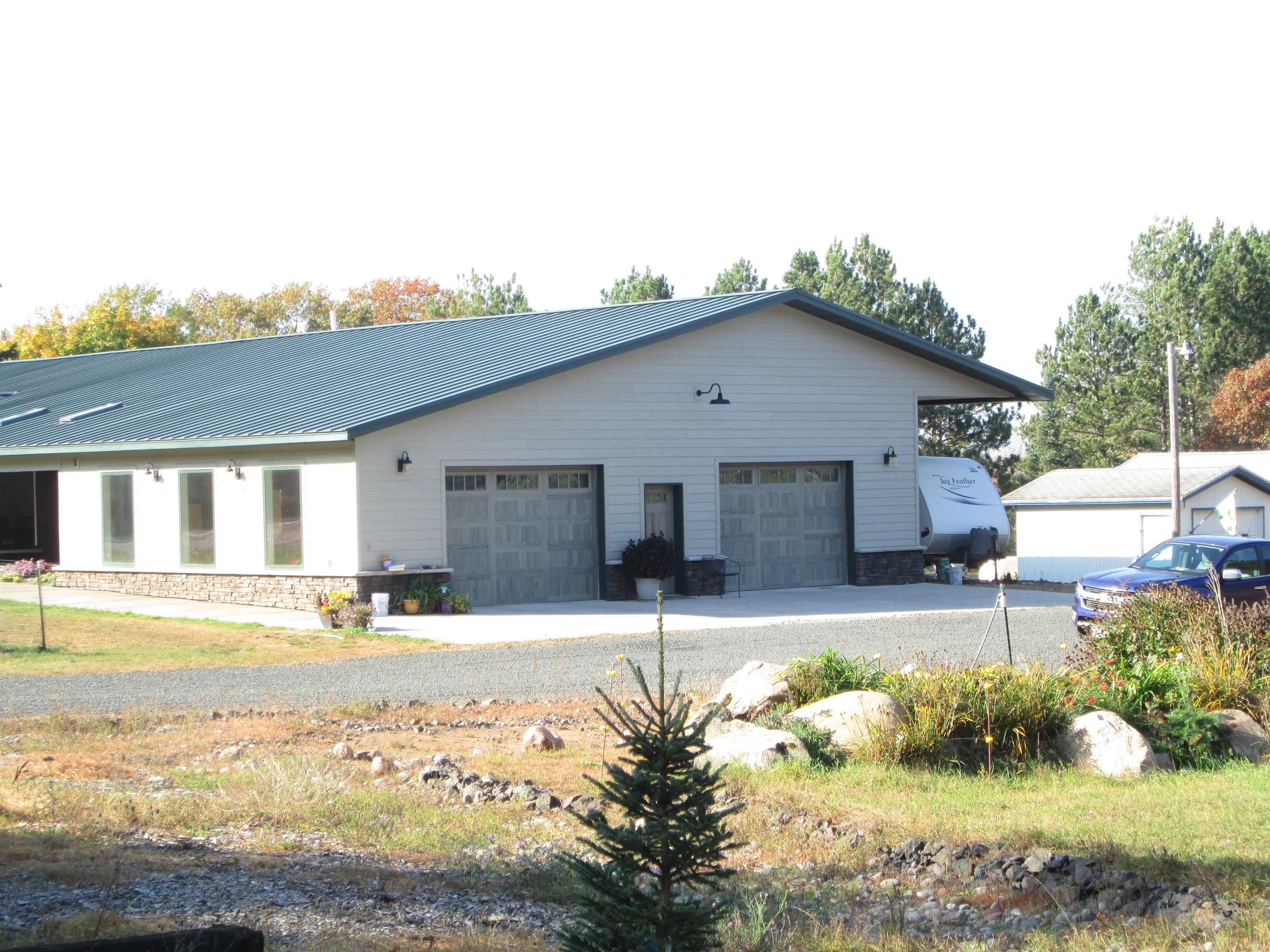 6030 Mitchell Road Iron River, WI 54847 - Photo 35 of 45 View of side of home with a metal roof
