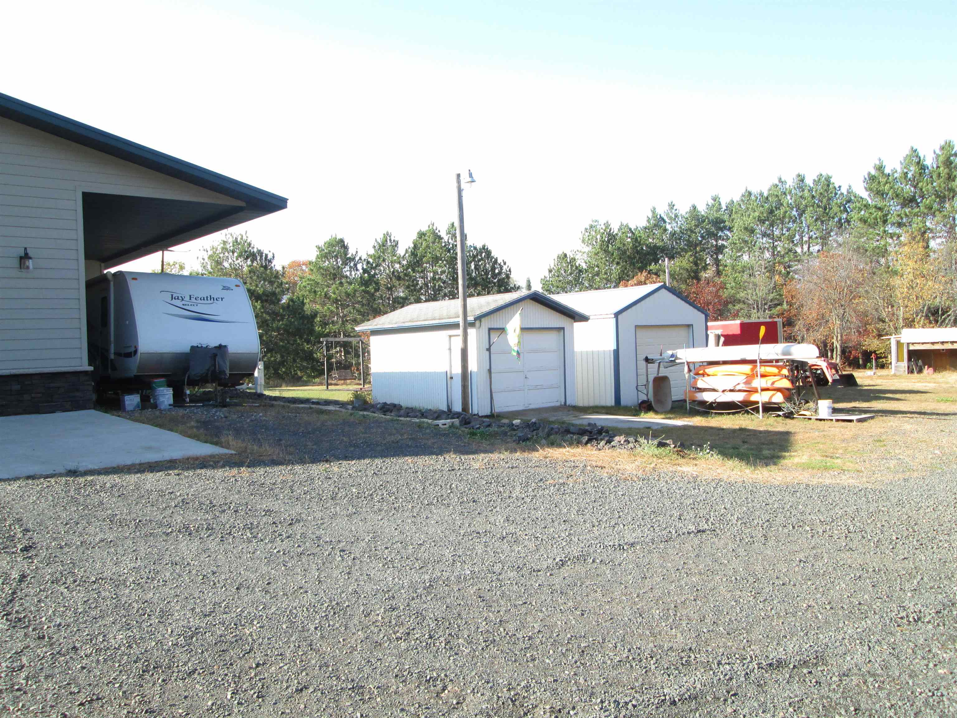 6030 Mitchell Road Iron River, WI 54847 - Photo 36 of 45 View of yard with a detached garage and an outdoor structure