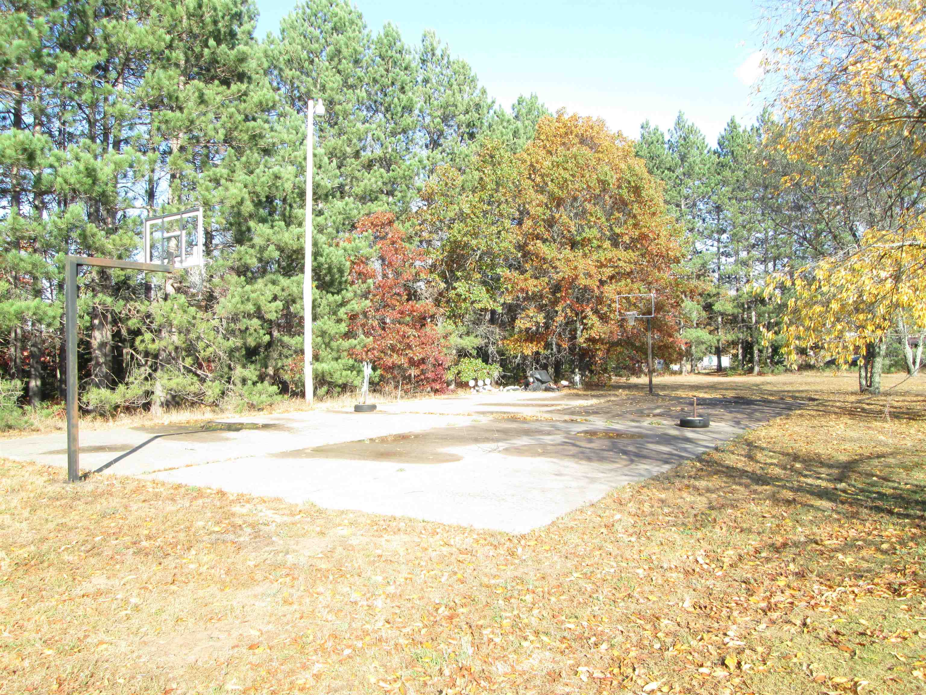 6030 Mitchell Road Iron River, WI 54847 - Photo 40 of 45 View of sport court featuring community basketball court and view of wooded area