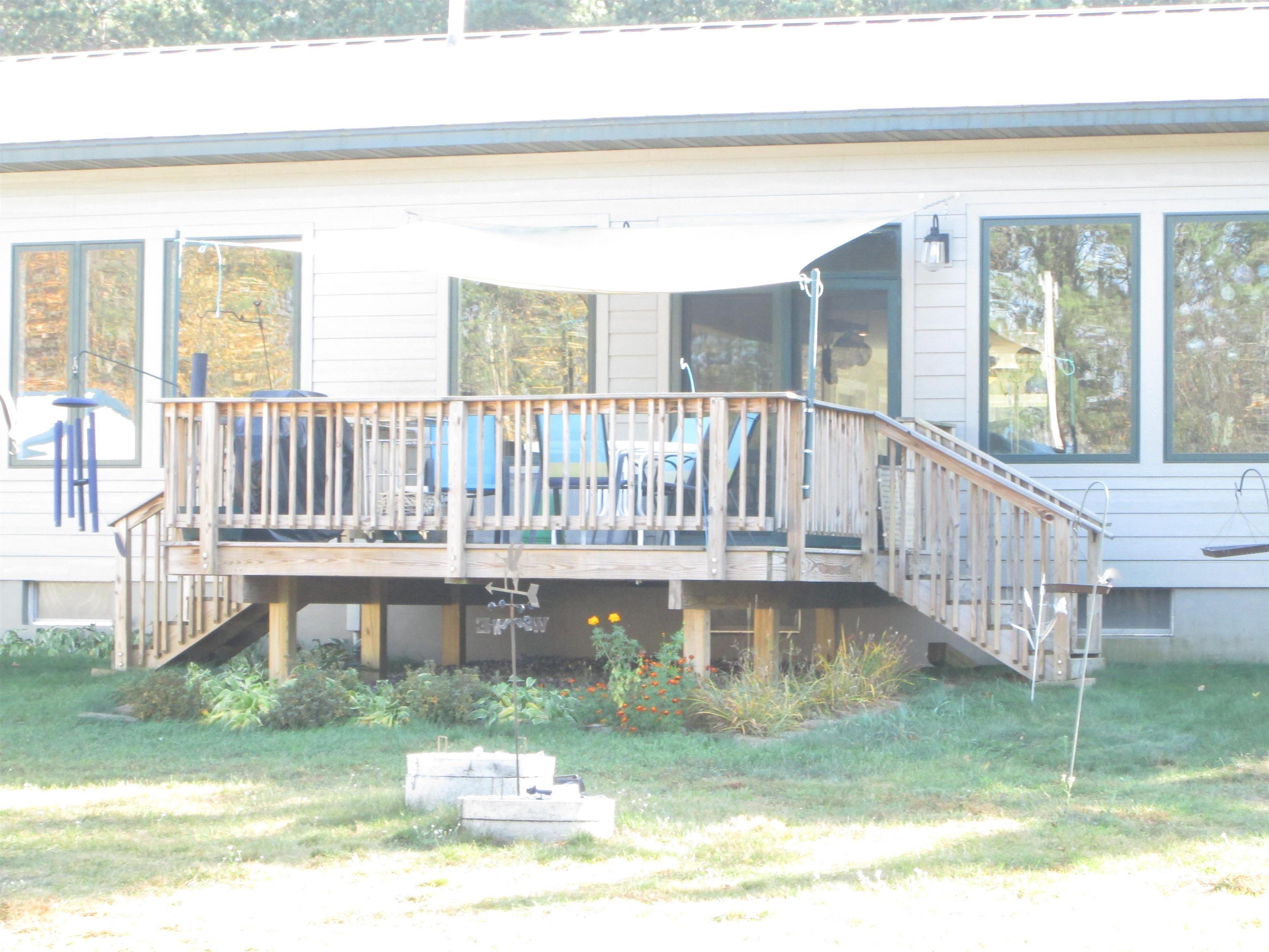 6030 Mitchell Road Iron River, WI 54847 - Photo 42 of 45 Rear view of house featuring stairs, a deck, and a yard