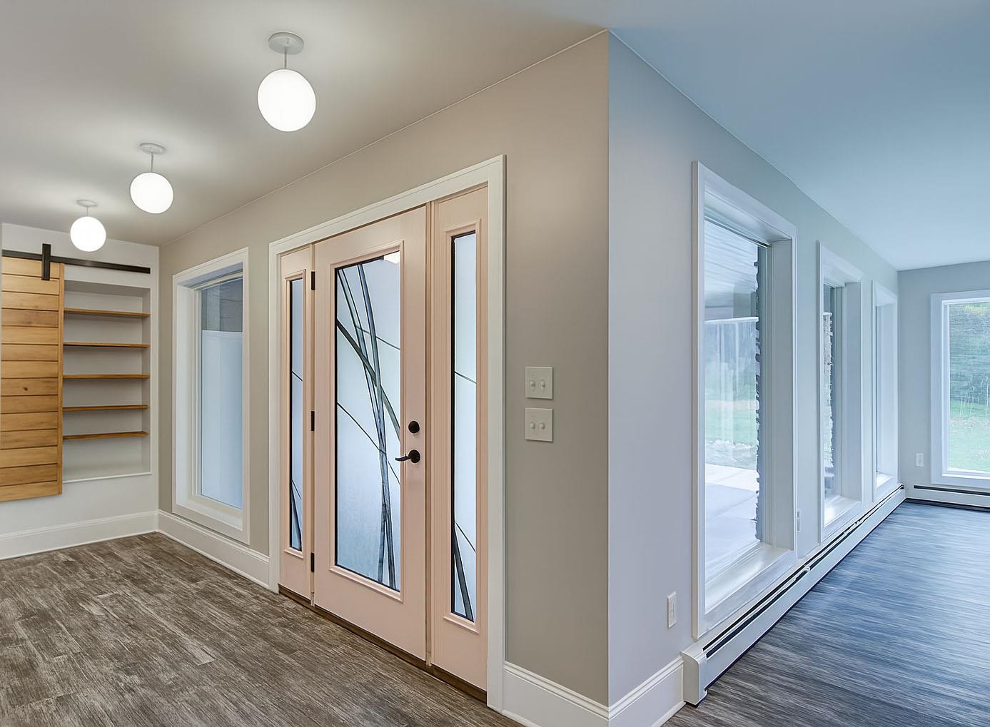 6030 Mitchell Road Iron River, WI 54847 - Photo 9 of 45 Doorway to outside with a barn door, a baseboard radiator, and wood finished floors