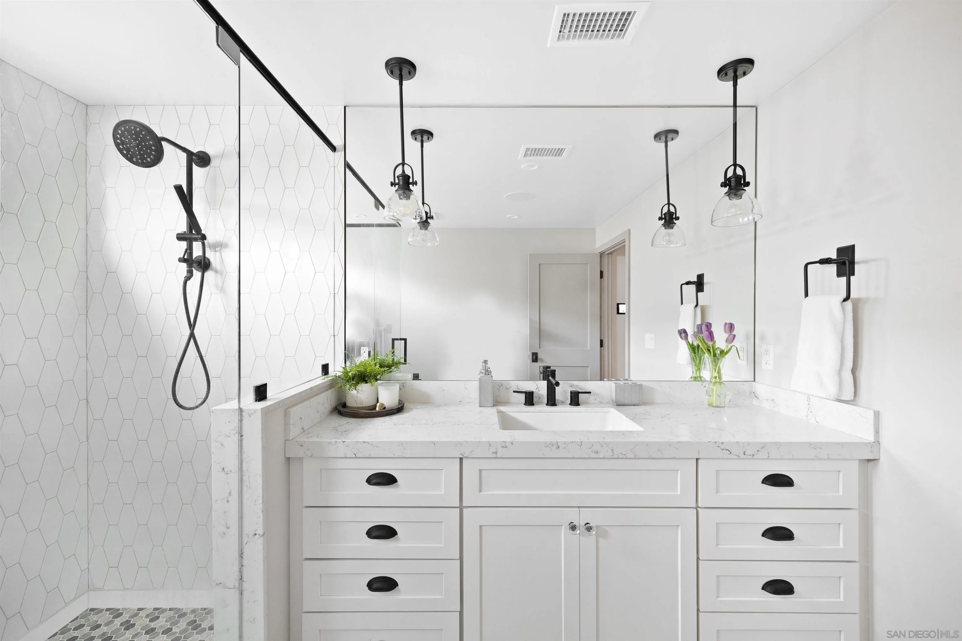 5351 Saxon Street San Diego, CA 92115 - Photo 17 of 34 a bathroom with a granite countertop sink a vanity and a shower
