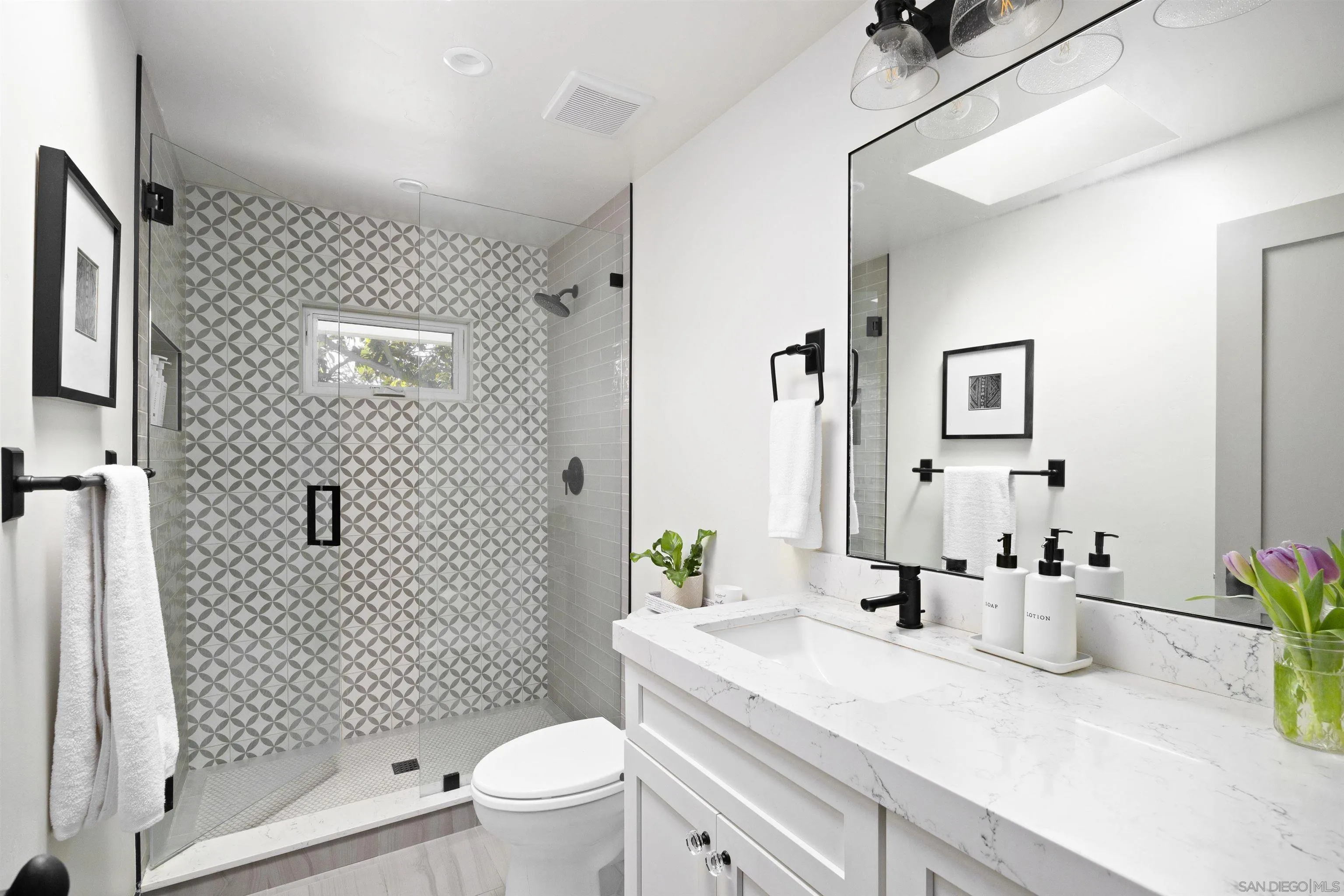 5351 Saxon Street San Diego, CA 92115 - Photo 21 of 34 a bathroom with a sink a toilet and shower