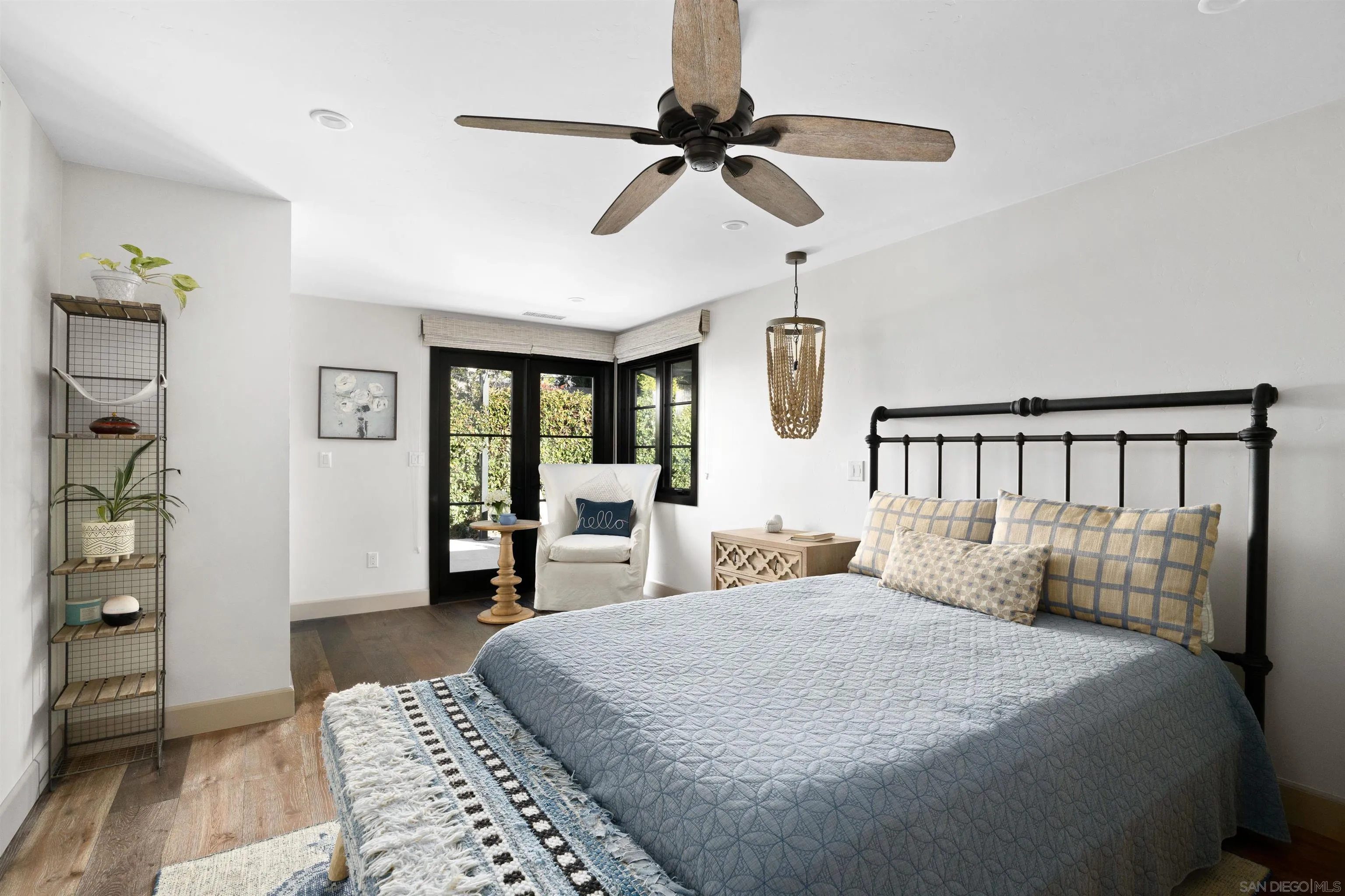 5351 Saxon Street San Diego, CA 92115 - Photo 22 of 34 a bedroom with a large bed and a chandelier