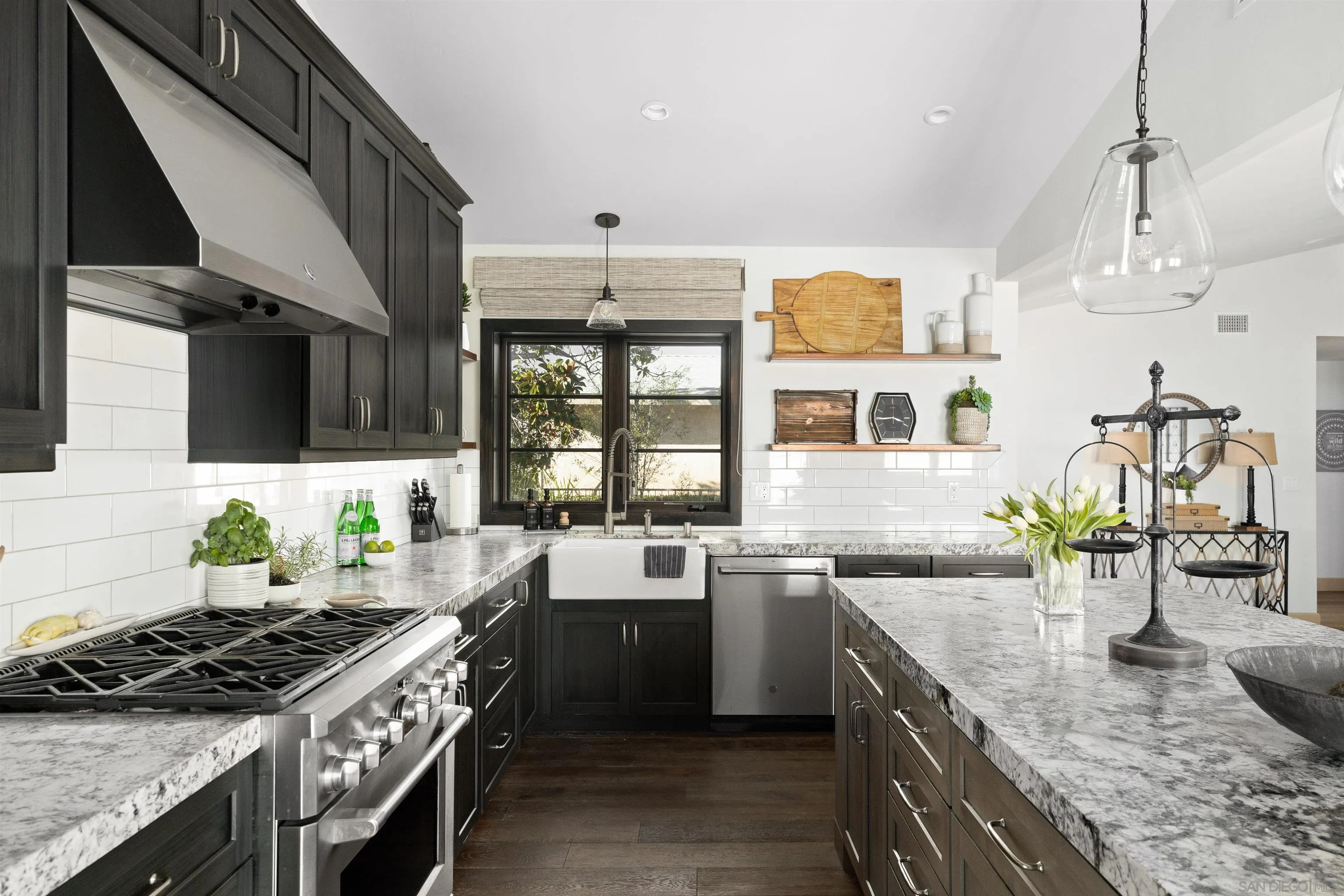 5351 Saxon Street San Diego, CA 92115 - Photo 6 of 34 a kitchen with stainless steel appliances granite countertop a sink a stove and a wooden cabinets