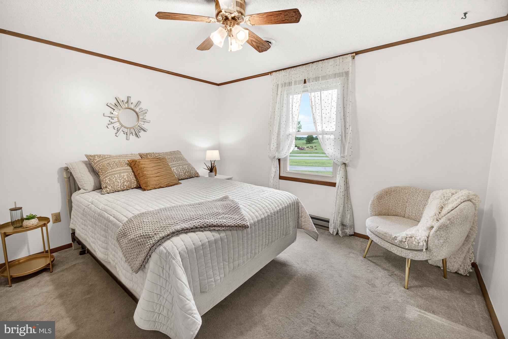 5601 Woodville Road Mount Airy, MD 21771 - Photo 27 of 54 a bedroom with a bed and a chandelier