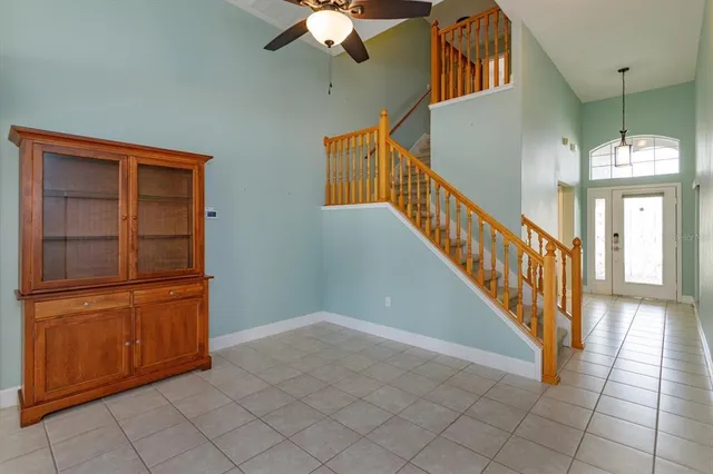 a view of a hallway with entryway wooden floor and cabinet