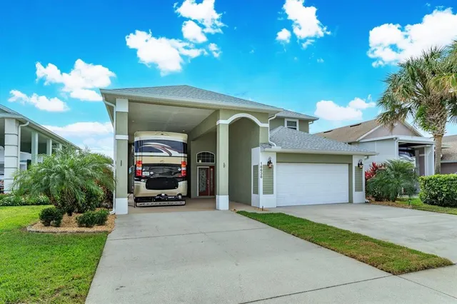 a front view of a house with a yard and a garage