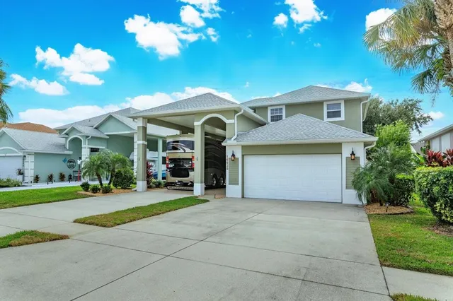a front view of a house with a yard and garage