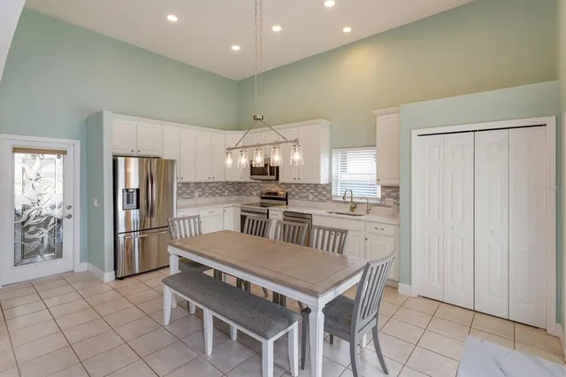 a kitchen with stainless steel appliances a refrigerator and a stove top oven