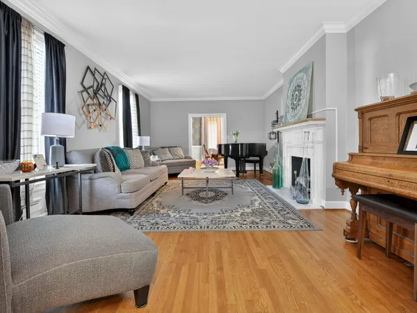 a living room with furniture a fireplace and a table