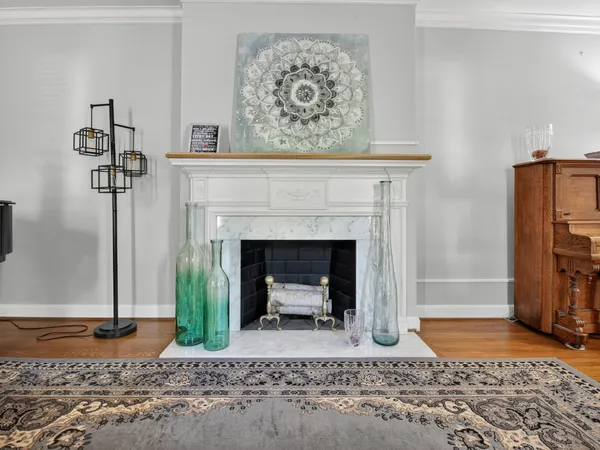 a dining room with furniture a chandelier and wooden floor