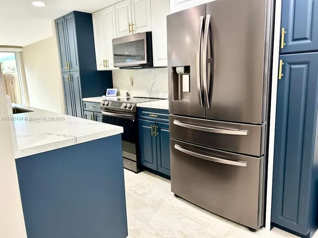 a close view of a sink and dishwasher with kitchen island