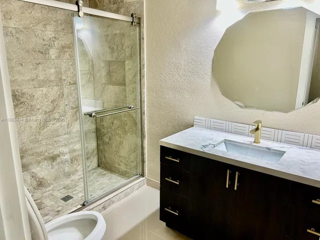 a view of a livingroom with wooden floor and flat screen tv