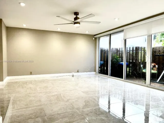 a kitchen with kitchen island a counter top space cabinets and stainless steel appliances