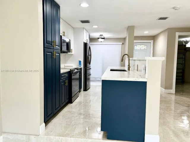 a kitchen with a sink and a mirror