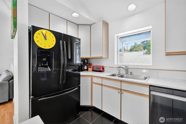 a kitchen with stainless steel appliances granite countertop a refrigerator and a sink