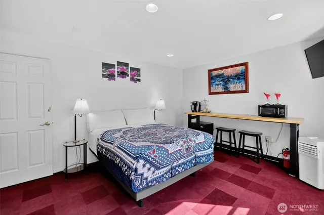 a bedroom with a bed and a table in it