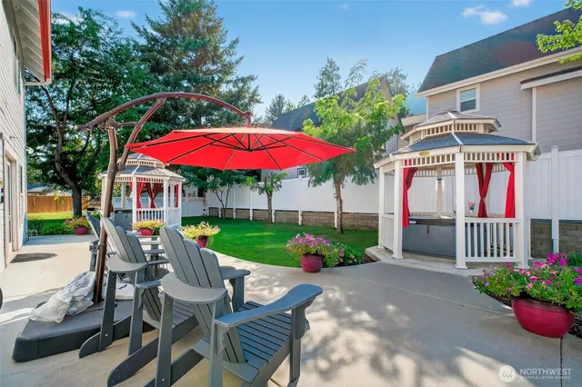 a view of a house with yard and sitting area