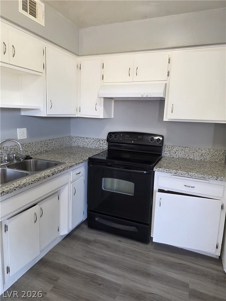 1089 East Desert Inn Road, Unit 3 Las Vegas, NV 89109 - Photo 12 of 15 Functional kitchen with ample cabinetry, a double sink, and a modern range.